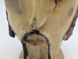 a close up of a vase with a face on it