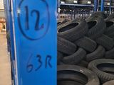 many tires stacked on a shelf in a warehouse