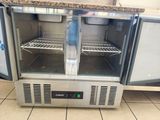 a refrigerated freezer in a kitchen with a granite counter top