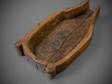 an old wooden boat with a wooden handle on a gray surface