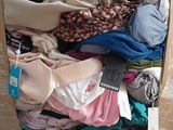 a box full of clothes that is sitting on the floor