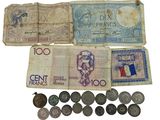 several different types of french currency are displayed on a white surface