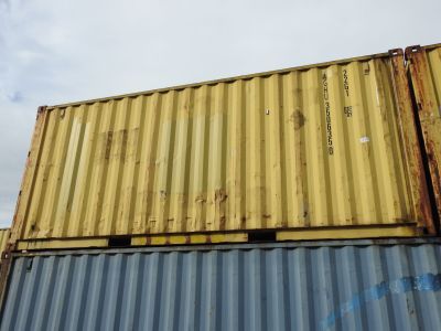a yellow and blue container sitting on top of a building