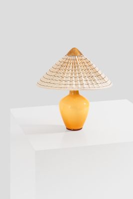 a yellow lamp that is on a white table