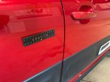 a close up of a red car door with a sticker on it