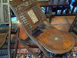 a chair that is sitting on a rug in a room