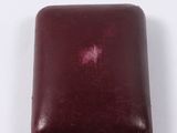 an image of a red leather box on a white surface