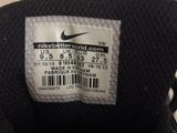 the label on the back of a pair of black sneakers