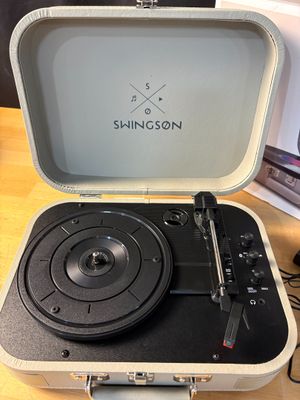 a record player sitting in a suitcase on a table