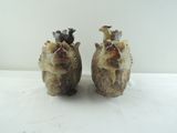 two small figurines of animals sitting on a table
