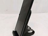 a cell phone that is on a stand on the table