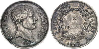 a close up of a silver coin with a crown on it