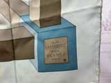 a scarf with a picture of a bottle of perfume on it
