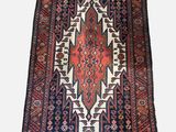 a rug with a red and blue design on a white background