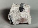 a rock with a black arrow on top of it