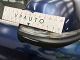 a close up of a sticker on a car ' s rear view mirror