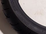 a tire that is sitting on the floor next to a wall