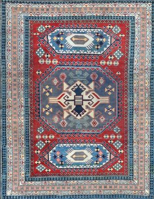a red, blue and green rug with geometric design