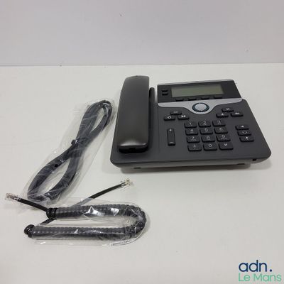 an image of a corded telephone with a cord and a charger on a table