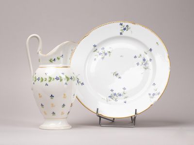 une assiette blanche et un vase blanc orné de fleurs bleues