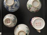 many cups and saucers that are on a table
