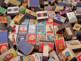 a pile of old matchboxes sitting on the floor