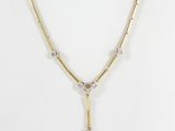 a gold and diamond necklace on a mannequin mannequin