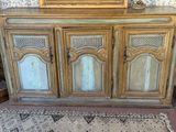 a wooden cabinet with a mirror on top of it