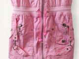 a pink vest with zippers and buttons on the front