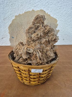a small basket with a bunch of dried flowers in it
