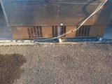a broken refrigerator that is sitting on the ground