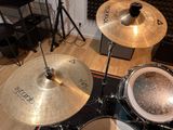 a drum set up in a recording studio with a microphone