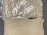 Deux oreillers, emballés dans du plastique, sont posés sur une table.