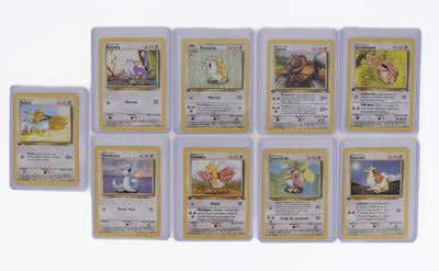 several pokemon cards are lined up on a white surface
