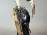 a close up of a sculpture of a bird on top of a helmet