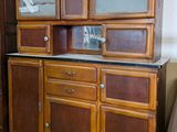 a wooden cabinet with glass doors in a room