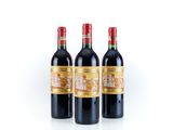 three bottles of red wine sitting next to each other on a white surface