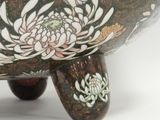 a black and white bowl with flowers on it