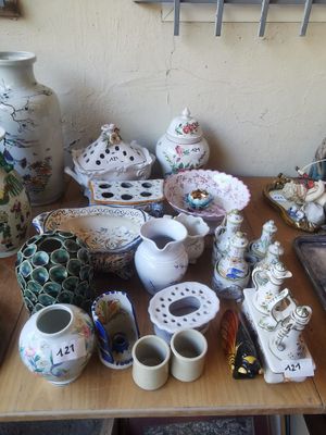 une table sur laquelle sont posés de nombreux vases et autres objets