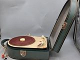 a green suitcase with a record player inside of it