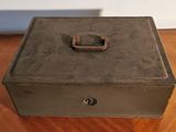a metal box with a latch on it on a table