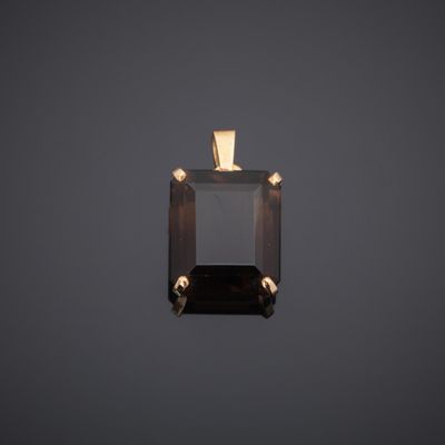 an image of a black diamond pendant on a gray background