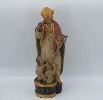 an old statue of a man with a dog on a pedestal