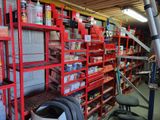 a red shelving in a garage with lots of shelves