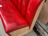 a red bench that is sitting in front of a building