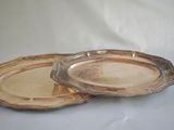 two silver plated trays on a white surface