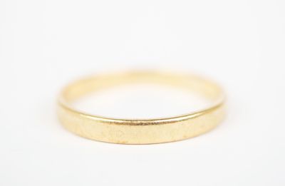 a close up of a gold ring on a white surface