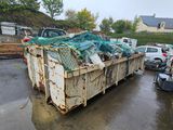 a dumpster full of wood in a yard