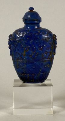 a blue vase with a lid sitting on a clear stand