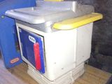 a small refrigerator sitting on top of a wooden table